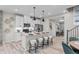 Modern kitchen featuring stainless steel appliances, white cabinets, an island, and pendant lighting at 9487 W 58Th Ln # C, Arvada, CO 80002