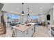 Open concept kitchen with island, stainless steel sink, view to the dining and living areas at 9487 W 58Th Ln # C, Arvada, CO 80002
