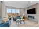 Cozy living room with large windows, stylish decor, and a modern fireplace at 9487 W 58Th Ln # C, Arvada, CO 80002