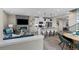 Open concept living space featuring a modern fireplace, kitchen island, and dining area at 9487 W 58Th Ln # C, Arvada, CO 80002