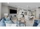 Inviting living room featuring a modern fireplace, open kitchen, and stylish furniture at 9487 W 58Th Ln # C, Arvada, CO 80002