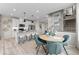 Bright and open floor plan featuring a modern kitchen with island, dining area, and stairs at 9487 W 58Th Ln # C, Arvada, CO 80002