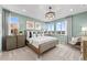 Serene main bedroom featuring a large bed, stylish decor, natural light, and plush carpeting at 9487 W 58Th Ln # C, Arvada, CO 80002