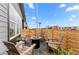 Charming patio area with a fire pit, comfortable seating, and a wood fence for privacy at 9487 W 58Th Ln # C, Arvada, CO 80002