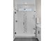 Contemporary glass shower with gray and white tile accents at 9487 W 58Th Ln # C, Arvada, CO 80002