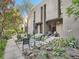 Landscaped backyard with seating and stepping stone pavers surrounded by foliage and mature trees at 1070 Race St # H, Denver, CO 80206