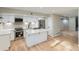 Modern kitchen with stainless steel appliances, white cabinets, stylish tile backsplash, and island at 1070 Race St # H, Denver, CO 80206