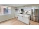 Updated kitchen with white cabinets, stainless steel appliances, modern backsplash, and island at 1070 Race St # H, Denver, CO 80206