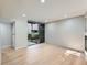 Bright living room with hardwood floors, fireplace, and a large window overlooking the courtyard at 1070 Race St # H, Denver, CO 80206