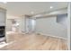 Spacious living room featuring hardwood floors and fireplace, flowing into kitchen area at 1070 Race St # H, Denver, CO 80206