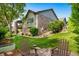 Beautifully landscaped backyard with a deck and sitting area on a lush lawn at 4532 Christensen Cir, Littleton, CO 80123