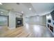 Finished basement featuring a fireplace, hardwood floors, and multiple windows at 4532 Christensen Cir, Littleton, CO 80123