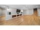 Finished basement featuring light wood floors, recessed lighting, built-in shelving, and staircase at 4532 Christensen Cir, Littleton, CO 80123