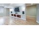 Finished basement with hardwood floors, media center, and accent lighting at 4532 Christensen Cir, Littleton, CO 80123