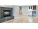 Finished basement featuring a fireplace, bar, and hardwood floors at 4532 Christensen Cir, Littleton, CO 80123