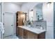 Well-lit bathroom with double vanity, marble countertop, and modern fixtures at 4532 Christensen Cir, Littleton, CO 80123