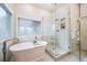 Luxurious bathroom with soaking tub and walk-in glass shower at 4532 Christensen Cir, Littleton, CO 80123