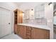 Bathroom featuring double sinks with wood cabinets and luxury lighting at 4532 Christensen Cir, Littleton, CO 80123