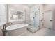 Luxurious bathroom with a soaking tub, separate shower, and natural light at 4532 Christensen Cir, Littleton, CO 80123