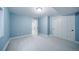Light blue bedroom with carpet, double door closet, and a window for natural light at 4532 Christensen Cir, Littleton, CO 80123