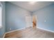 Light-filled bedroom with hardwood floors, blue walls, and a closet and doorway at 4532 Christensen Cir, Littleton, CO 80123