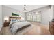 Bedroom features hardwood floors, a ceiling fan, and a window seat, and a King bed at 4532 Christensen Cir, Littleton, CO 80123