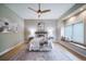 The bedroom features an area rug, ceiling fan, and natural lighting from the windows and window seat at 4532 Christensen Cir, Littleton, CO 80123