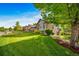 Charming home with well-manicured lawn, mature trees, and attractive brick and siding exterior at 4532 Christensen Cir, Littleton, CO 80123