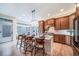 Kitchen features a large island with seating, stainless appliances, and wood cabinets, great for cooking at 4532 Christensen Cir, Littleton, CO 80123