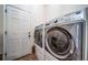 Modern laundry room with side by side washer and dryer at 4532 Christensen Cir, Littleton, CO 80123