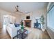 Bright living room with a fireplace and a modern ceiling fan is the perfect place to relax and unwind at 4532 Christensen Cir, Littleton, CO 80123