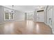 Spacious living room boasts gleaming hardwood floors and large windows filling the space with natural light at 4532 Christensen Cir, Littleton, CO 80123