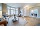 Open-concept living area with hardwood floors, a bay window, and seamless access to other rooms at 4532 Christensen Cir, Littleton, CO 80123