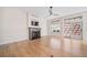 Bright living room boasts hardwood floors, fireplace, and sliding glass doors to the outside at 4532 Christensen Cir, Littleton, CO 80123