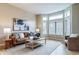Bright and airy living room featuring hardwood floors, a bay window, and a comfortable seating arrangement at 4532 Christensen Cir, Littleton, CO 80123