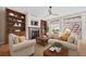 Inviting living room with a cozy fireplace, built-in shelving, and comfortable seating at 4532 Christensen Cir, Littleton, CO 80123