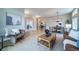 Inviting open-concept living area features hardwood floors, comfortable seating, and an elegant dining space at 4532 Christensen Cir, Littleton, CO 80123