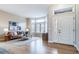 Inviting living room featuring hardwood floors, a cozy leather sofa, and an abundance of natural light at 4532 Christensen Cir, Littleton, CO 80123