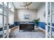 Stylish home office with a half blue wall, featuring a ceiling fan, a desk, and bright natural light at 4532 Christensen Cir, Littleton, CO 80123