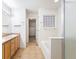 Bright bathroom featuring a double vanity, shower, and a soaking tub at 9763 E Carolina Pl, Aurora, CO 80247