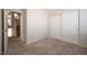 Comfortable bedroom with neutral paint and carpet and sliding door closet at 9763 E Carolina Pl, Aurora, CO 80247