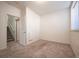 Cozy bedroom with plush carpet, neutral walls and door to stairwell at 9763 E Carolina Pl, Aurora, CO 80247