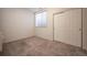 Cozy bedroom with carpet floors, closet, and a bright window for natural light at 9763 E Carolina Pl, Aurora, CO 80247