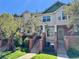 Charming townhome with brick accents, a well-manicured lawn, and blossoming trees at 9763 E Carolina Pl, Aurora, CO 80247