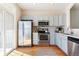 Bright kitchen with stainless steel appliances, light blue cabinets, and hardwood floors at 9763 E Carolina Pl, Aurora, CO 80247