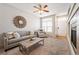 Bright living room boasts a modern sofa, decorative mirror, and lots of natural light at 9763 E Carolina Pl, Aurora, CO 80247