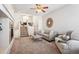 Inviting living room featuring plush carpeting, a cozy fireplace, and a comfortable seating area at 9763 E Carolina Pl, Aurora, CO 80247