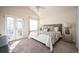 Bright main bedroom featuring a vaulted ceiling, ceiling fan, and private balcony at 9763 E Carolina Pl, Aurora, CO 80247