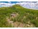 A beautiful home nestled among a verdant forest at 8838 Hillview Rd, Morrison, CO 80465