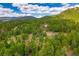 A beautiful home is set among a verdant forest at 8838 Hillview Rd, Morrison, CO 80465